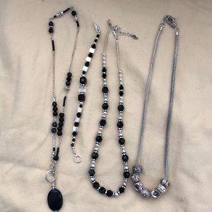 3 silver and black necklace is and 1 bracelet